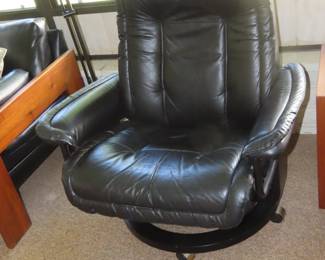 Leather pushback recliner with footstool.