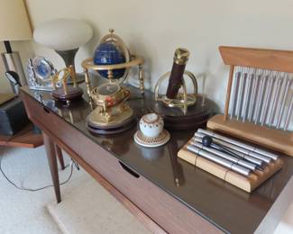 Globes, clocks, chimes and desk.