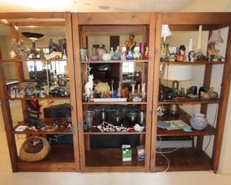 Shelves filled with figures, collections, bookends, vases.