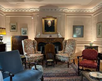 And inviting living room with antique and vintage furniture, lighting accessories, and art