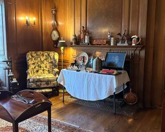 Paneled library, setting with wing chair and bar accessories