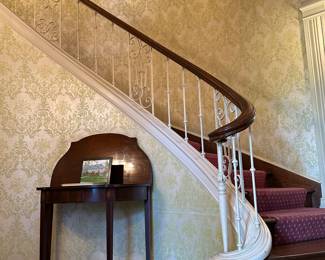 A grand sweeping staircase to upstairs