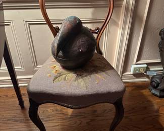 Balloon back parlor chair with needlepoint seat, holding repoussé metal bird box