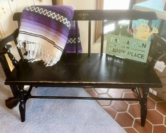 Second view of black with woven blanket and metal sign