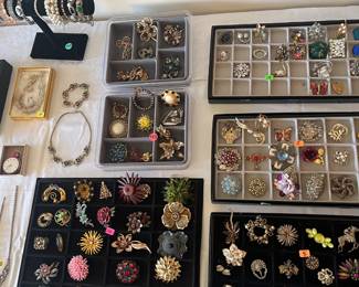 assortment of brooches, charms and pendants 