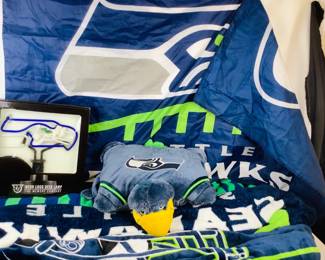COCH328 Seahawks Memorabilia II 3 Blankets to warm yourself in the stands, 1 Neon Desk Lamp, 1 pillow and 1 Flag. The flag is approximately 53' Long x 37' Tall. The blankets are each approximately 5' Wide.