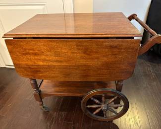 A19 - $125. Rolling Tea Cart with single drawer. Measures 33.25" long with handle x 20" wide with sides down (41" wide with sides out) x 28.75" tall. Great condition - sturdy. 