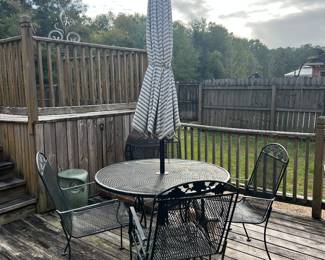 7-piece Iron table set includes 4 chairs and umbrella and umbrella stand.