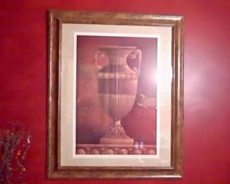 Urn picture under glass with brownish gold frame.