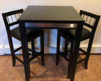 High top black wood table with silver accent.  Two matching chairs.  Table measures:  30"W x 30"L x 42"H