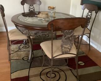 Heavy iron glass top table four chairs