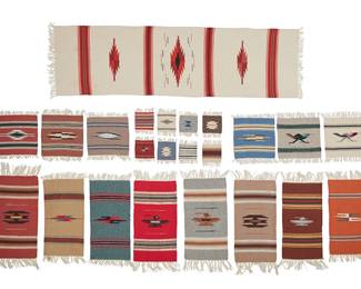295
A Large Group Of Chimayo Textiles
Mid-20th century; New Mexico
Six with fabric label: Ortega's Weaving Shop / 100% Wool Hand Woven / Chimayo, New Mexico
A group of handwoven fringed wool table textiles in various colors and sizes, with geometric and figural designs, including stepped and serrated diamonds, striped banding, roadrunners, and thunderbirds, comprising eight drinks coasters (variously: 4.5" H x 4.5" W), six medium placements (variously: 10" H x 10" W), eight longer table mats (variously: 20" H x 10" W), and one long table runner (58" H x 18" W), 23 pieces
Estimate: $300 - $500