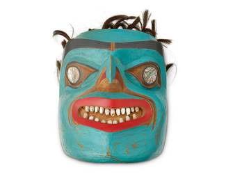 70
A Northwest Coast Polychrome Mask
Mid-20th century; Pacific Northwest Coast
A carved cedar mask with painted green face and red and black/dark blue painted features, inlaid abalone eyes, shell teeth, and tufts of hair to forehead
9.75" H x 7.5" W x 6.75" D
Estimate: $300 - $500