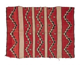 27
A Navajo Wearing Blanket
Late 19th/early 20th century, Diné
A banded blanket woven in red, cream, and black wool with five stepped zigzag bands
36" H x 47" W
Estimate: $500 - $700