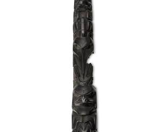 82
A Fragmented Haida Argillite Totem Carving
Late 19th century; Pacific Northwest Coast
Appears unmarked
The carved stone totem sculpture originally representing multiple figures including a bear, raven, wolf, and human, many shown clutching or devouring other creatures, with a concave carved back side and two-step base, which has fractured into three large fragments with various missing sections
Assembled: 27" H x 3.5" W x 3.5" D; base: 2.25" H x 7.75" W x 7.25" D
Estimate: $1,000 - $2,000