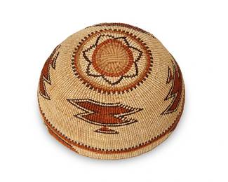 197
A Polychrome Hupa/Yurok/Karuk Basketry Hat
Early/mid-20th century; Northern California
A twined basketry hat with four floating imbricated motifs and banding at rim
3.5" H x 7.875-8" Dia.
Estimate: $400 - $600