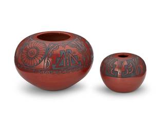 235
Minnie Vigil (B. 1931, Santa Clara Pueblo)
Two redware pottery vessels, Mid/late 20th century
Larger marked to underside: Minnie / Santa Clara
Each burnished red clay pot with grey painted banded kiva step motifs to the shoulders
2 pieces
Larger: 6.125" H x 9.25" Dia.; smaller: 4" H x 5.325" Dia.
Estimate: $500 - $700