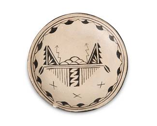 234
Sara Arquero (B. 20th Century, Cochiti Pueblo)
A Cochiti plate in black and white, mid-20th century
Inscribed to base: Mrs. Sara Arquero / August 10, 1967 / St. Lawrence Day / Gift by Juana (Grandma)
The plate with black cloud and lightning motifs on beige ground and underside with terracotta wash
6" Dia.
Estimate: $200 - $300