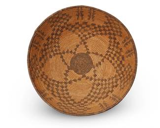 44
An Apache Basketry Bowl
Early 20th century; Southwestern United States
A large coiled tray with central star and checkerboard motifs, with alternating columns to rim
3.625" H x 14.25" Dia.
Estimate: $700 - $900