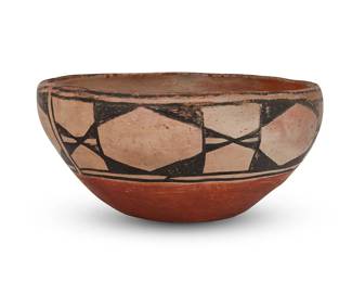 214
A Santo Domingo Pueblo Pottery Dough Bowl
Early 20th century; New Mexico
Marked in felt pen to underside: MZC; additionally etched to the side: P.C.
The polychrome dough bowl with black-on-white geometric banded motif above a red base
4.75" H x 9.5" Dia.
Estimate: $300 - $500