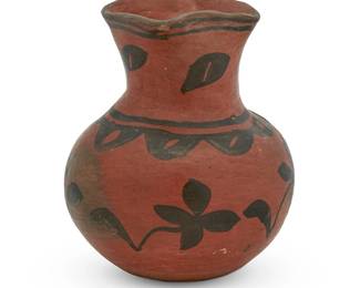 272
A San Ildefonso Pueblo Redware Pottery Jar
Early 20th century; New Mexico
Appears unmarked
The black on red vase of modified olla form with flared and squared neck featuring a floral motif
6.5" H x 5.25" Dia.
Estimate: $200 - $300
