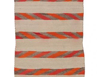 118
A Navajo Regional Rug
Early 20th century, Diné
Woven in orange, red, cream, and light grey wool with multiple diagonally striped bands
51" H x 21" W
Estimate: $200 - $300