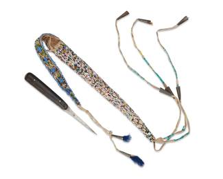 129
A Sioux Beaded Hide Sheath And Awl
Late 19th/early 20th century; Northern/Central Plains
Comprising a narrow cylindrical sheath with "Crazy" beads on hide, with beaded cover flap, and quilled fringe dangles with metal cone drops, together with an pointed metal awl formed from a re-purposed utensil with wood handle, 2 pieces
Sheath: 8" H x 0.875" W; dangles: 11.5" H; awl: 5.25" H x 0.625" W
Estimate: $500 - $700