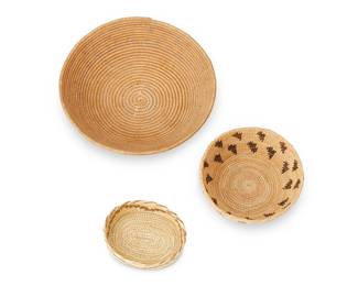 331
A Group Of Native American Baskets
Three works:

A Washoe basketry bowl
Early 20th century; Great Basin
A coiled tray with faded hooked sawtooth band
2" H x 8.5" Dia.

A small round basket
Mid-late 20th century; likely Central/Northern California
A small coiled bowl with two bands of floating motifs
2" H x 5.5" Dia.

A small oval Papago basket
Mid-20th century, Tohono O'odham; Arizona
With stepped zigzag motif and overcast stitching to rim
1.25" H x 4.25" W x 3.5" D

3 pieces
Estimate: $300 - $500