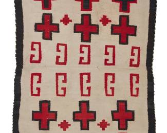 169
A Navajo Regional Rug
Early 20th century, Diné
Woven in cream, red, black, and blue wool with multiple floating crosses and hooked motifs to center
52" H x 31" W
Estimate: $400 - $600