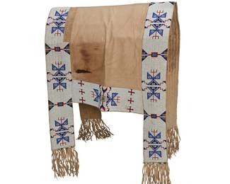 121
A Sioux Beaded Hide Saddle Blanket
Late 19th/early 20th century; Northern/Central Plains
With a double-layered cotton canvas body framed by heavily beaded sinew-sewn hide side panels in alternating geometric motifs in white, red, blue, green, and metallic beads, with four tabs trimmed with green and white chunky cylindrical beads and added hide fringing
Overall: 67" H x 24.75-27" W; fringe: 7" L approximately
Estimate: $3,000 - $5,000