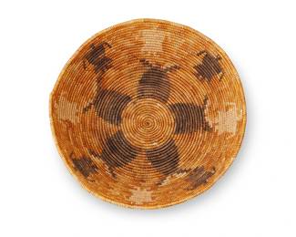 33
A Polychrome California Mission Basket
Early 20th century; Southern California
A coiled figural tray with a band of alternating dark and light figures to sides and five-lobed flower to center
3" H x 10.5" Dia.
Estimate: $1,000 - $1,500