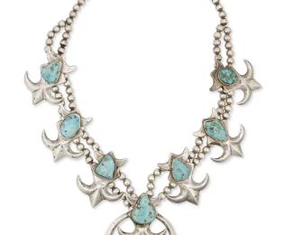 240
A Navajo Silver Squash Blossom Necklace
Mid/late 20th century, Diné
Appears unmarked
A sand-cast silver and stone-set turquoise double-strand necklace suspending six fleur-de-lis blossoms and finished with a naja
22" to 26" L x 3" H
213.4 grams gross
Estimate: $1,000 - $1,500