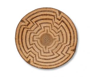 42
A Pima Basketry Tray
Early 20th century, Akimel O'odham; Southwest United States
A small coiled tray with central concentric stepped motif
1.5" H x 8.5" Dia.
Estimate: $200 - $400