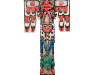 149
A Northwest Coast-Style Polychrome Totem
Mid/late 20th century
Appears unmarked
Carved wood sculpture with polychrome painted details of multiple various figures, with a blue raven head and detachable red wings to top, above a second bird figure, likely a Blue Jay, and a green frog figure, 3 pieces
80.5" H x 36" W x 17.75" D approximately
Estimate: $800 - $1,200