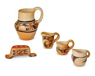320
A Group Of Hopi Pueblo Polychrome Pottery Items
Early/mid-20th century; Arizona
Each appears unmarked
The yellowware group comprising a three-color handled Nampeyo-style pitcher with banded geometric motif, a three-holed pen holder with geometric motif, and three black on beige handled creamers with various traditional motifs, 5 pieces
Pitcher: 6.75" H x 6" W x 5" D; smallest creamer: 2.875" H x 3.5" W x 2.5" D
Estimate: $400 - $600
