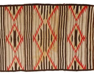 28
A Navajo Banded Blanket
Early 20th century, Diné
Woven in brown, grey, cream, red, and yellow wool with alternate striped and sawtooth diamond banded motifs
59.5" H x 41" W
Estimate: $500 - $700