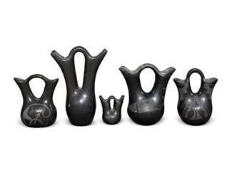 303
A Group Of Puebloan Blackware Wedding Vases
Mid/late 20th century; Southwestern United States
Diminutive vase incised to underside: Linda Askan [b. 1954] / Santa Clara Pueblo / '97; one with indecipherable signature
The burnished pottery vases in various sizes, four with black on black painted designs, 5 pieces
Largest: 7.75" H x 5.325" W x 3" D; smallest: 3" H x 2.5" W x 1.75" D
Estimate: $200 - $400