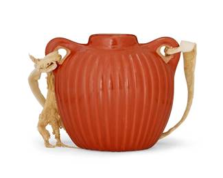 306
Alvin Baca (B. 1966, Santa Clara Pueblo)
A redware pottery canteen, late 20th century
Incised to underside: Alvin Baca
The melon ribbed vessel with opposed lug handles and hide strap
4.5" H x 5.5" W x 3.25" D
Estimate: $100 - $200