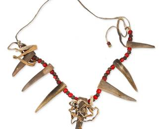 243
A Native American Antler Necklace
Early 20th century or later
Comprising a necklace of seven antler tips strung on hide cording with red glass white-heart trade bead and silver bead spacers and hide fringing
24" L x 3.5" H
Estimate: $500 - $700
