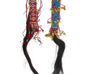 137
Two Plains Beaded Hide Horse Tail Ornaments
Late 19th/early 20th century; Great Plains
Comprising two polychrome beaded hide ornaments with attached long horse hair/horse tail segments, one with calico fabric lining, and each with various additional quilled hide fringing with tin cone feathered tips, 2 pieces
Each: 36" H x 2.25" W approximately
Estimate: $600 - $800