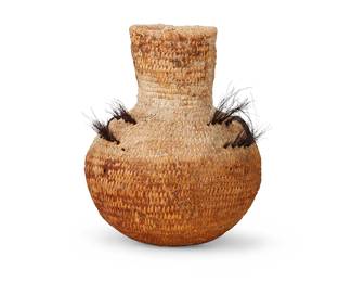335
An Apache Water Basket
Late 19th century; Southwest United States
A coiled tall olla with remnants of braided horsehair handles
9.5" H x 7" Dia.
Estimate: $200 - $300