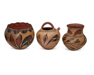 343
Three Santo Domingo Pueblo Polychrome Pottery Vessels
Early 20th century; New Mexico
Each appears unmarked
The three-color pots comprising a top-handled teapot (7.25" H x 6.25" Dia.), a varnished bowl with piecrust crimped rim (6.25" H x 7.75" Dia.), and a varnished jar with flared neck and puki indentation to underside (6.5" H x 6.5" Dia.), each with various floral and foliate motifs on buff ground, 3 pieces
Estimate: $300 - $500
