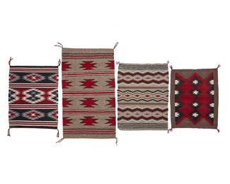 256
A Group Of Navajo Regional Textiles
Mid/late 20th century, Diné
Comprising four works woven in black, white, red, and grey wool including a small mat with three bands of sawtooth diamonds (27.5" H x 21" W), a longer mat with four bands of floating red diamonds (39.5" H x 22.5" W), a mat with Wide Ruins-style banding (29.5" H x 21.5" W), and a small mat with central stacked column of sawtooth diamonds (26" H x 20.5" W), 4 pieces
Estimate: $400 - $600