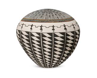 266
Margaret Seymour (1931-2006, Acoma Pueblo)
An Acoma Pueblo pottery seed pot, mid-20th/21st century
Signed to underside: M. Seymour / Acoma / NM / USA / [pictograph of Acoma Pueblo]
The black-on-white pottery vessel with black fineline starburst pattern to top, edged with a polychrome and a figural band, and with black and white diamond columns beneath, all on white slip glaze
7" H x 7.5" Dia.
Estimate: $100 - $200