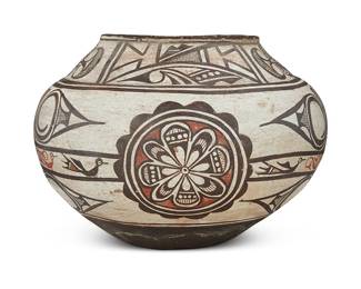 49
A Zuni Pueblo Polychrome Pottery Olla Jar
Late 19th century; New Mexico
Appears unmarked
The three-color jar with painted rose medallions and banded avian motifs to waist, including puki indentation to underside
9.25" H x 12.5" Dia.
Estimate: $3,000 - $5,000