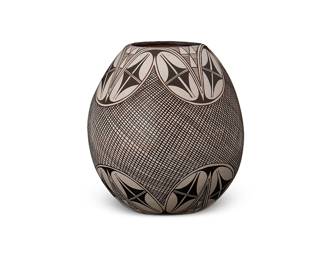 270
Sylvia Naha (1951-1999, Hopi Pueblo)
A fine line pottery vase, late 20th century
Signed with artist's cipher to underside
The egg-shaped vase with geometric and fine line designs on white buff glaze
6.125" H x 5.75" Dia.
Estimate: $500 - $700