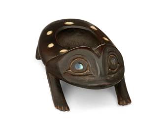 85
A Northwest Coast Frog Grease Bowl
Early 20th century; Pacific Northwest Coast
A frog-form carved wood oval dish with legs, likely cedar, with inlaid abalone eyes and inlaid shell accents to bowl
3.25" H x 4.375" W x 9.25" D
Estimate: $500 - $700