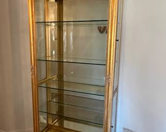 Gold framed lighted curio cabinet