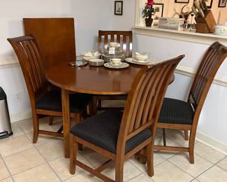 Round table with six chairs, one leave 