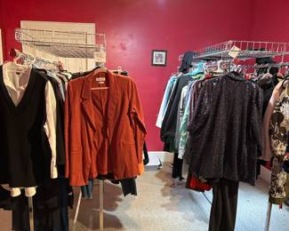 2 stationary clothing racks with metal baskets on top